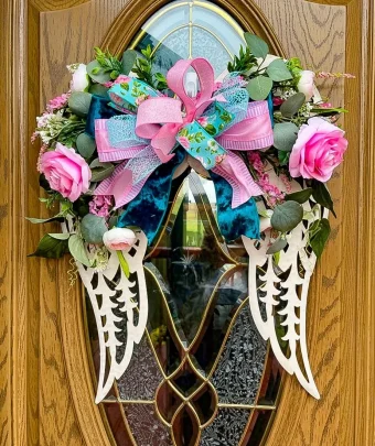 Filigree Angel Wings make a perfect Front Door Wreath, Wall Decoration, or a Common Funeral Service & Gravesite Memorial Decoration. Many People Search for Angel Wings that are incorporated in their Sympathy flower arrangements, and this is perfect! Whether it's a gift for someone else, or a keepsake for yourself, This 24" Angel Wing Display is a Tasteful way to pay Tribute to anyone you love. Same Day Delivery 7 Days a Week to LaPorte and New Carlisle, IN | Hand Crafted and Delivered by your local LaPorte Florist, Country Charm Floral and Gifts.