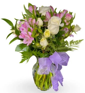 Love Story Bouquet | A beautiful blend of pastel hues. White/cream Roses and Soft Lavender Alstroemeria in a glass vase. Fitting for romantic celebrations like Valentine's Day, as well as sympathy bouquets. Order same day delivery locally throughout LaPorte County and New Carlisle, IN 7 Days a week with Country Charm Floral and Gifts, your local Rolling Prairie Florist Shop.