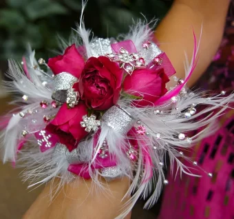 Prom Wrist Corsage | High Quality Fresh Flowers on an Adjustable Wrist Band, Decorated Boldly and Beautifully with Vibrant Flowers, Feathers, Rhinestones and Bling & Matching Ribbon. We offer Simple Style Corsages and Blinged Out Corsages with More Flowers and Rhinestones. Order The Perfect Wrist Corsage to Match Your Prom Attire! Country Charm Floral & Gifts Delivers to All Addresses in New Carlisle and all Throughout LaPorte County Areas in Northwest Indiana- 7 Days a Week.