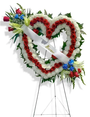Our Patriotic Memorial Heart Shaped Funeral Wreath stands as an Emotional Tribute, Tenderly Commemorating a Cherished Soul. Freshest, Best Quality Funeral Flower Arrangements by your Favorite Local Florist in LaPorte County, Indiana- 7 Days a Week.