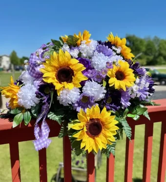 Purple Cemetery Saddle | A Perfect Combination of Sunflowers and Purple Artificial Flowers Meant to Decorate your Loved One's Gravesite/Headstone. Choose one of our Beautiful, Sturdy, Headstone Saddles in Variety of Spring and Summer Colors | Local Florist in LaPorte, IN.