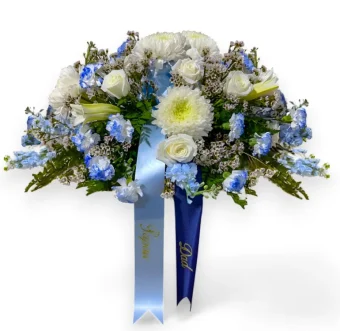 Blue Casket Spray | An elegant and tasteful display of fresh blue and white flowers, displayed on top of casket during memorial and funeral services. Country Charm Floral and Gifts only uses the highest quality flowers for all arrangements- especially Funeral Flowers and Memorials. Order today for fast, local delivery to LaPorte, Indiana- Your local funeral florist delivering 7 days a week to churches, funeral homes, and celebration of life events.