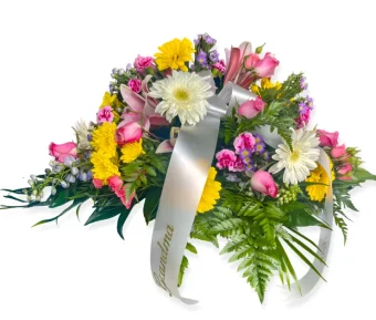 Celebrate Life Casket Spray | A Vibrant, Colorful Arrangement of the Freshest Premium Flowers, this Piece will Serve as a Beautiful Tribute to your Loved One. Filled with a variety of bright colors, this casket spray will bring life to a loved one's Memorial Service or Celebration of Life, displaying meaningful love and devotion to your loved one. Country Charm Floral and Gifts Delivers Sympathy and Funeral Flowers 7 days a week to LaPorte County, Indiana.