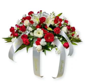 Red and White Casket Spray | Meant as a tasteful display of devotion to a loved one who has passed, and fitting for either a man or a woman. Arranged beautifully with only the freshest red and white flowers of the highest quality, this casket spray will surely be the elegant arrangement you want to add to a Celebration of Life or Funeral/Memorial Service. Country Charm Floral and Gifts is your LaPorte Funeral Florist Delivering 7 Days a Week Directly to Funeral Homes, Churches, and Celebration of Life Services in LaPorte County, Indiana.