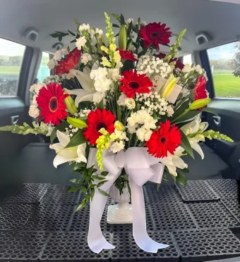 Our impressive Remembrance Basket is composed of Crisp White Lilies, Gladiolus, and Vibrant Red Gerbera Daisies, accented beautifully with fresh greenery and presented in an Urn-style Basket. Same Day Flower Delivery to Funeral Service and Celebration of Life to LaPorte County and New Carlisle, Indiana and Berrien County, Michigan- 7 Days a Week.