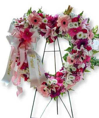 Our Pink Funeral Heart is a beautiful expression of love and sympathy, crafted with an assortment of fresh, premium pink flowers in the shape of an open heart. Designed to offer comfort and convey heartfelt condolences, this elegant arrangement is perfect for honoring a loved one during a visitation, funeral service, or celebration of life. Florist for Funerals and All Occasions throughout LaPorte County and New Carlisle, Indiana and New Buffalo, Berrien Springs, Michigan- 7 Days a Week.