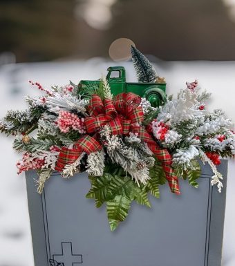 Our Green Truck Winter Saddle is handmade with high quality artificial snowy pine, with perfect winter accents of berries and pinecones. The popular Little Green Truck is the main feature of this headstone saddle, finished off with a gorgeous seasonal bow. LaPorte County, Indiana Florist Delivery 7 Days a Week to Michigan City, LaPorte, and New Carlisle, Indiana.
