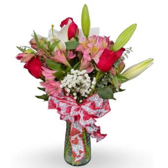 Be My Valentine Bouquet of Premium, Fresh-Cut Roses, Lilies, Alstroemeria, and accents of Eucalyptus and Baby's-Breath in a glass vase with a romantic bow covered in cute Valentine hearts. Best Florist for Valentines Day and Any Occasion- Delivering 7 Days a Week to LaPorte County, Indiana and New Carlisle, Indiana.