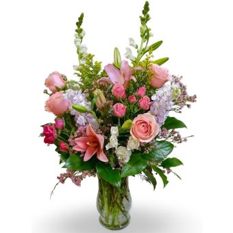 Our Elegant Bouquet is Arranged with Premium Quality, Fresh-Cut Assorted Pastel Hues of Pink & Light Purple Fresh-Cut Flowers such as: Lilies, Roses, Spray Roses, and Stock or Hydrangea with lovely accents of Wax Flowers or Baby's-Breath and fresh seasonal greenery in a glass vase. The elegance of this pastel fresh flower arrangement is fitting for just about every occasion. Fast Delivery to LaPorte and New Carlisle, Indiana 7 Days a Week.