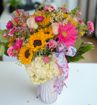 Send a stunning Birthday Blooms Bouquet to your loved one at work or at home as fast as today! This beautiful fresh flower arrangement is packed full of assorted fresh, vibrant Sunflowers, Daisies, Roses, Carnations, and lush greenery in a tasteful white vase. Our popular Birthday Blooms bouquet is perfect for any occasion, not only birthdays. Send it to a loved one or friend at work, home, or even a local hospital to brighten anyone's day with this gorgeous statement piece. Local flower delivery to New Carlisle and LaPorte County, Indiana 7 Days a week.