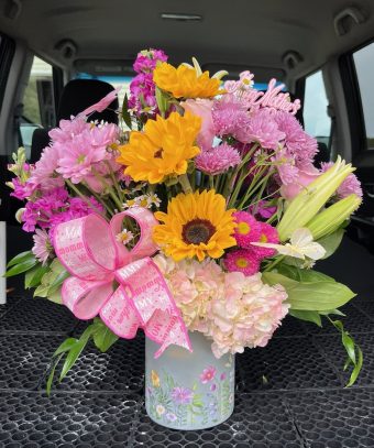 Mothers Day Surprise - A Vibrant, Fragrant Floral Arrangement perfect for Mother's Day & Springtime Joy. Nestled within this large, cheerful arrangement—you’ll find an abundant mix of fresh, vibrant flowers decorated with artificial butterflies. The beautiful and feminine floral vase ties everything together, especially for Mother's Day! This makes the perfect gift for any mom or mommy-to-be! Local Flower Delivery throughout LaPorte County, Indiana 7 Days a Week.