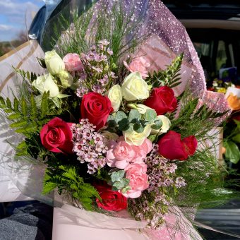 Hand Tied Bouquet of Assorted Pink, Red, and White Premium Fresh Roses. Wrapped elegantly in pink, feminine floral wrap and hand delivered anywhere in LaPorte County, IN and New Carlisle, IN- 7 Days a Week. Your Local, Favorite Florist Shop with the most Popular Bouquets this year!