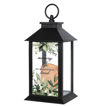 Shine a light on the life of a loved one with our Comforting Memorial Lantern. Topped with a simple & sweet decorative flower arrangement, this LED (Flameless Candle) is perfect for both indoor/outdoor decor and makes for a meaningful, everlasting keepsake for those enduring a painful loss. Local Delivery Daily to LaPorte County, Indiana.